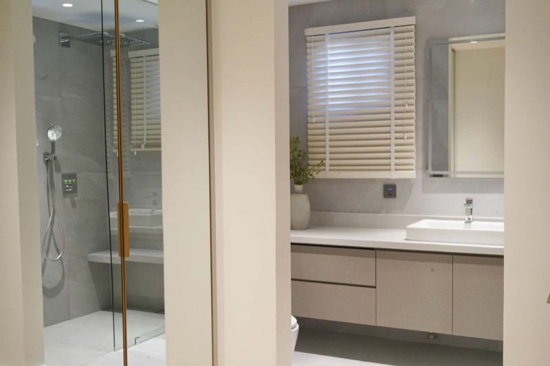 Bathroom vanity next to a glass shower enclosure