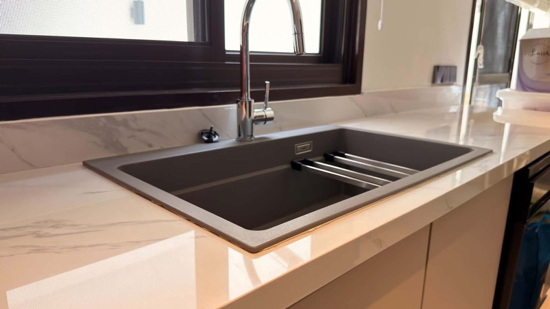 Marble-look kitchen counter with a black composite sink
