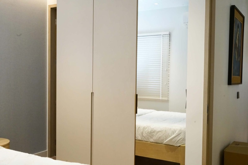 Condo hallway fitted with handle-less greige wardrobes
